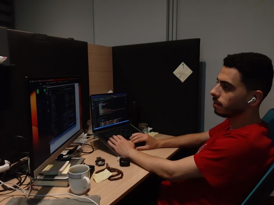 Ahmed Ahmed working at his desk